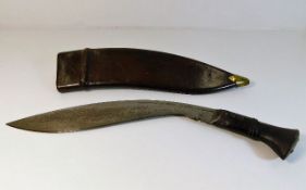 A Gurkha Kukri dagger with leather scabbard dated