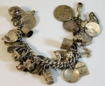 A silver charm bracelet with numerous charms 80.4g