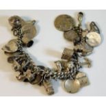 A silver charm bracelet with numerous charms 80.4g