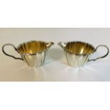 A pair of French silver creamers with gilt lining