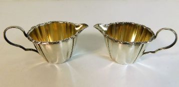 A pair of French silver creamers with gilt lining