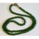 An early 20thC. Jade bead necklace 16in long 11.1g