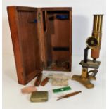 An antique brass microscope with slides