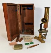 An antique brass microscope with slides