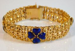 An 18ct gold bracelet with enamelled decor & red s