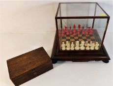 An antique German polished bone chess set within glass case & chess pieces box