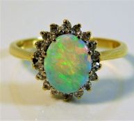 An 18ct gold ring set with opal & 0.2ct diamonds s