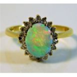 An 18ct gold ring set with opal & 0.2ct diamonds s