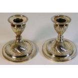A pair of silver candle holders with twist decor,