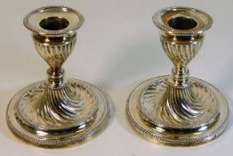 A pair of silver candle holders with twist decor,
