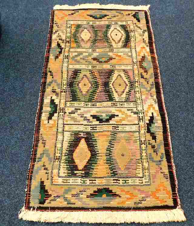 A woven Gabbeh rug 55in long x 27in wide