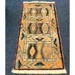 A woven Gabbeh rug 55in long x 27in wide