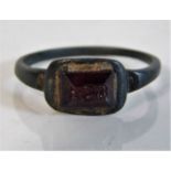 A jewelled Roman bronze ring with red stone