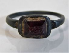 A jewelled Roman bronze ring with red stone