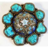 A decorative silver brooch set with turquoise & ce