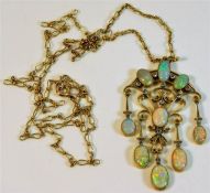 A yellow metal chain & pendant set with fourteen s