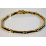 A 14ct gold bracelet set with diamond & sapphire 8