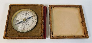 A small pocket size compass in a/f case 2.5in wide