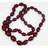 A cherry amber style beaded necklace approx. 30in