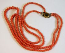 A c.1900 two string coral beaded necklace, faults