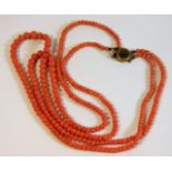 A c.1900 two string coral beaded necklace, faults