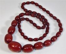 A cherry amber coloured bakelite style beaded neck