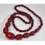 A cherry amber coloured bakelite style beaded neck