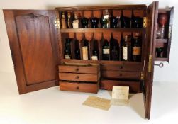 An antique apothecary cabinet & contents with fitt