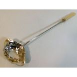 An antique French silver ladle with ivory handle