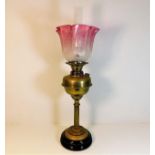 A 19thC. brass oil lamp with etched cranberry glas