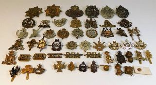 A quantity of cap badges & other military badges