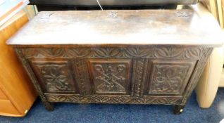 A carved oak coffer with hinged top 42in wide x 25