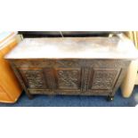 A carved oak coffer with hinged top 42in wide x 25