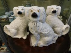 A pair of Staffordshire dogs 12in tall & one other