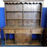 A large antique oak dresser with three drawers with brass handles & cupboard under 83in high x 71in