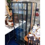A pair of electric lit modern glass display cabine
