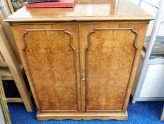 A walnut entertainment cabinet