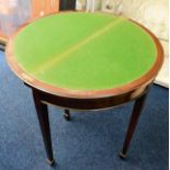 An antique mahogany card table with card holder un