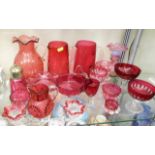 A quantity of mostly antique cranberry glass wares