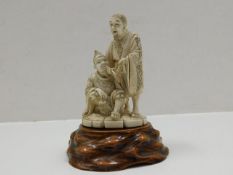 A Japanese carved ivory figure group set on organic plinth approx. 6.5in, signed to base