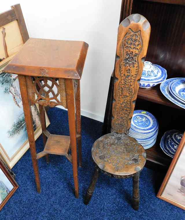 A carved spinning chair twinned with a decorative