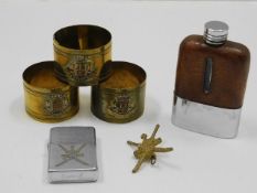 Three trench art style napkin rings, a Zippo light