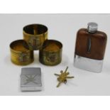 Three trench art style napkin rings, a Zippo light