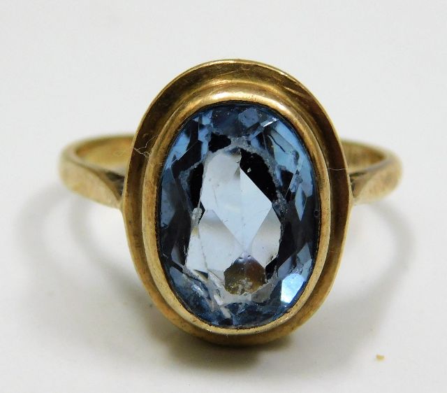 A 9ct gold ring set with blue paste stone size T 4