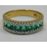 An 18ct gold ring set with emerald & diamonds size