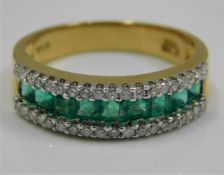 An 18ct gold ring set with emerald & diamonds size