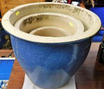 A set of three blue glazed planters, largest 15in