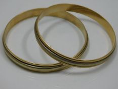 A pair of two colour 18ct gold bangles 72g