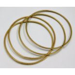 A set of four yellow metal bangles, one a/f test a