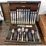 An oak cased plated cutlery set twinned with a woo